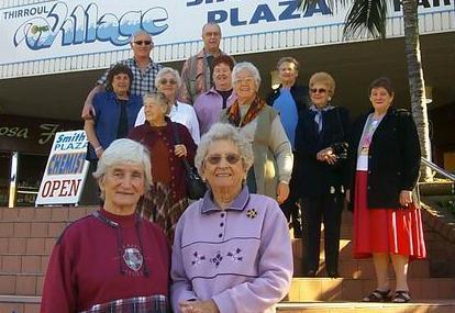 Edith Robinson (left) and Elaine Broadhead with former employees of Hardies Rubber factory.  The site is now the Thirroul Plaza Shopping Plaza in 2003.